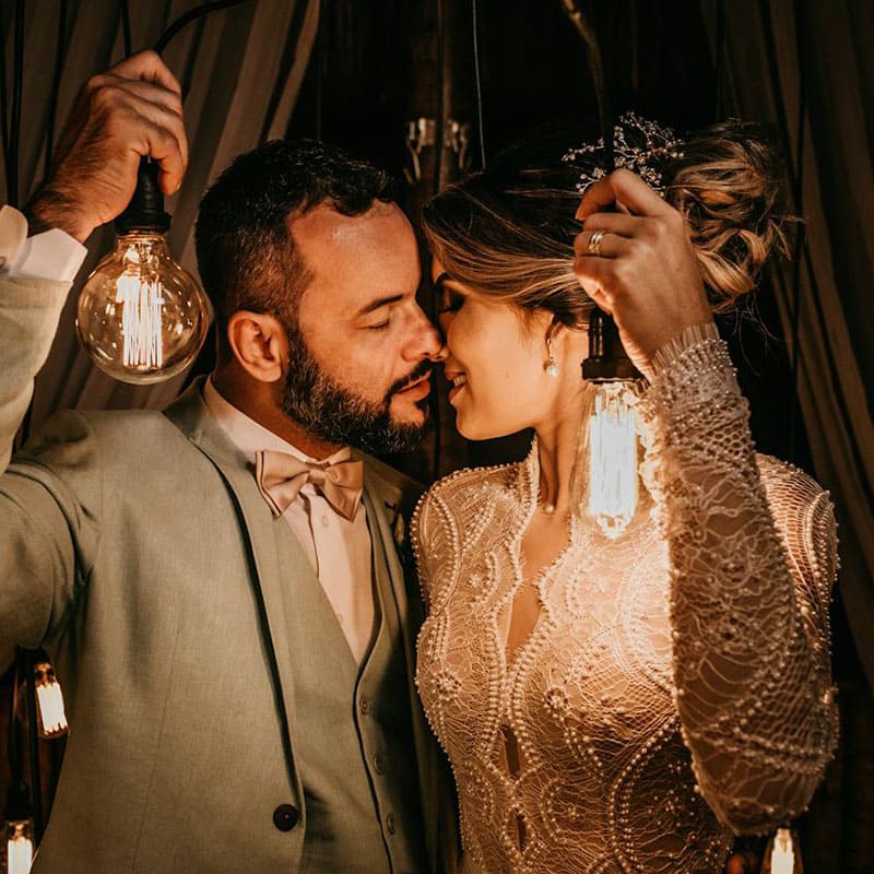 intimate wedding couple holding light bulbs